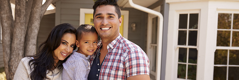 family in front of a home